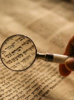 Person holding magnifying glass photo